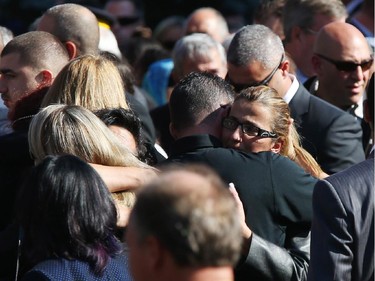 Friends and family console each other after the funeral for Staff Sgt. Kal Ghadban.