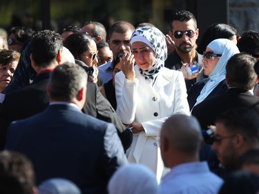 Friends and family console each other after the funeral for Staff Sgt. Kal Ghadban.