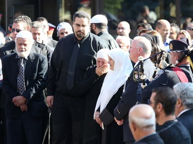 Friends and family console each other after the funeral for Staff Sgt. Kal Ghadban.