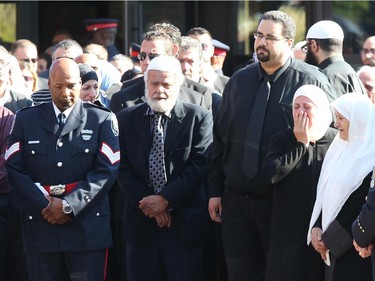 Friends and family console each other after the funeral for Staff Sgt. Kal Ghadban.