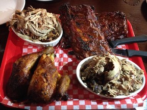 The BBQ Feast platter at Capital City Smokehouse includes, clockwise from top left, pulled pork, a rack of ribs, brisket and best of all, smoked chicken.