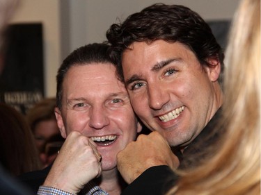 From left, former charity boxing fighters Walter Robinson and Justin Trudeau ham it up at the cocktail reception for the Hope Live gala held at the GCC on Monday, Oct. 27, 2014.