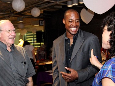 From left, George Langill, retired CEO of the Royal Ottawa Health Care Group, and his daughter, Kendra, were among the guests to mingle with Redblacks quarterback Henry Burris at the inaugural HERA Mission charity gala in support of widows and orphans in western Kenya, co-hosted by the Ottawa Redblacks CFL team at the TD Place on Wednesday, Oct. 15, 2014.