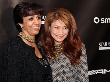 from left, Habiba Chakir and Mimi Surada pose at the photo booth at the Ottawa Symphony Orchestra's Fanfare post-concert reception held Monday, Oct. 6, 2014, at the National Arts Centre.