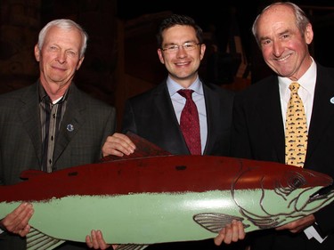 From left, organizing committee member Claude Pryor, Conservative Nepean-Carleton MP Pierre Poilievre and committee chair Dawson Hovey show off some of the fish-themed artwork auctioned off at the 18th annual Fall Run Dinner for the Atlantic Salmon Federation, held at the Canadian Museum of History on Wednesday, Oct. 18, 2014.