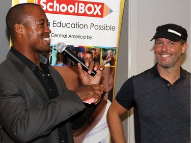 From left, Redblacks quarterback Henry Burris discusses football with Shawn Simpson from TSN 1200 at the inaugural HERA Mission charity gala in support of widows and orphans in western Kenya, co-hosted by the Ottawa Redblacks CFL team at the TD Place on Wednesday, Oct. 15, 2014.