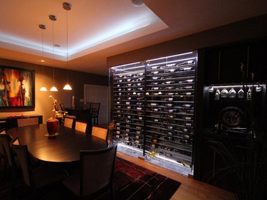 Newcomer Capital Cellars won renovation under $60,000 for this project, in which a sleek wine cellar acts as a classy divider between a dining room and adjacent entertainment area.