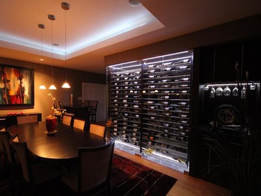 Capital Cellars created a custom stainless steel and glass wine cellar to act as a divider between the dining room and entertainment area without closing off the space.