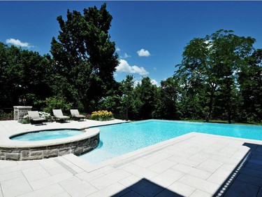 The grounds include an infinity pool, putting green, basketball court and outdoor kitchen.