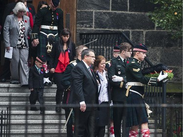 Kathy Cirillo, third from right, the wife of Cpl. Nathan Cirillo, Laureen Cirillo, walks as her son Marcus Cirillo, second from left, follows behind during Nathan Cirillo's funeral at the Christ's Church Cathedral.