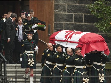 Kathy Cirillo, left,, walks out from Christ's Church Cathedral as the casket of her son Cpl. Nathan Cirillo is carried out.