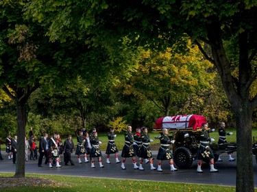 The casket of Cpl. Nathan Cirillo makes its way up a tree-lined hill during his funeral procession.