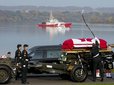 The casket of Cpl. Nathan Cirillo is loaded onto an artillery piece at the start of his funeral procession in Hamilton.
