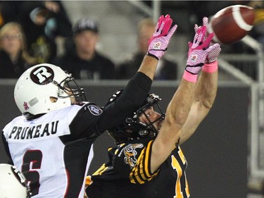 Hamilton Tiger-Cats' Luke Tasker can't make the catch as Ottawa Redblacks' Antoine Pruneau defends during first half CFL action.