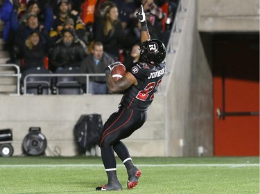 Running back Jeremiah Johnson #27 of the Ottawa Redblacks celebrates a touchdown against the the Hamilton Tiger-Cats in the first quarter.