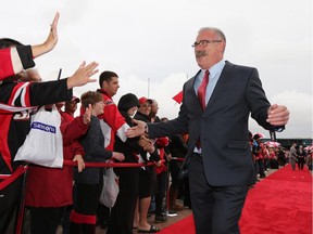 Head coach Paul MacLean is greeted on the red carpet.