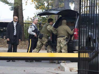 Heavily-armed RCMP officers arrive at 24 Sussex Drive, the residence of Canada's Prime Minister Stephen Harper on Wednesday, Oct. 22, 2014.