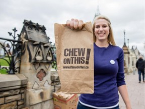 Helena Towle volunteers for the ChewOnThis! campaign by handing out free lunch bags at Wellington St. at O'Connor in front of Parliament Hill Friday to draw attention to Canadians who have to rely on food banks each month to put food on their tables.