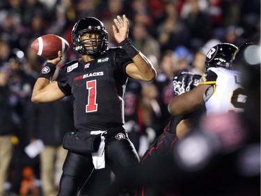 Henry Burris of the Ottawa Redblacks throws against the Hamilton Tiger-Cats during first half CFL action.