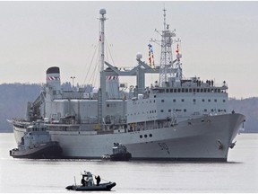 HMCS Preserver is pushed by tugs in Halifax harbour on Oct. 19, 2011. The Canadian navy is going to retire four veteran ships that have been in service for decades.