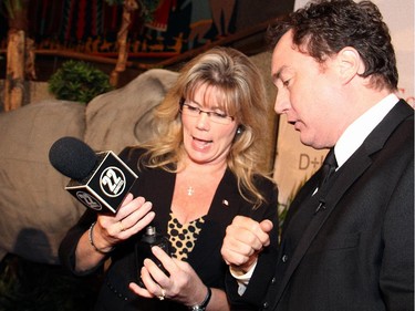 In mid-interview, Heritage Minister Shelly Glover helped to fix the microphone belonging to Mark Critch from This Hour Has 22 Minutes at the Ottawa premiere of Elephant Song on Monday, Sept. 29, 2014, at the National Arts Centre.