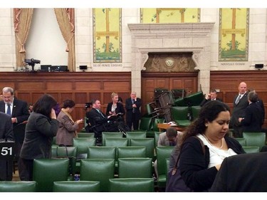 In this photo provided by Conservative MP Nina Grewal, members of Parliament barricade themselves in a meeting room on Parliament Hill.