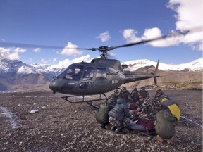 In this photo provided by the Nepalese army, soldiers prepare to airlift an avalanche victim in Thorong La pass area, Nepal, Wednesday, Oct. 15, 2014.