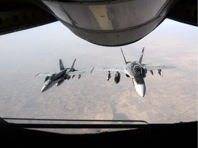 In this Oct. 4 photo, released by the U.S. Air Force, a formation of U.S. Navy F-18E Super Hornets, supporting operations against ISIL, leaves after receiving fuel from a KC-135 Stratotanker over Iraq.