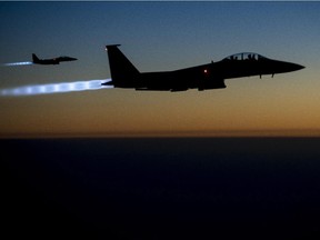 In this Tuesday, Sept. 23, 2014, photo, released by the U.S. Air Force, a pair of U.S. F-15E Strike Eagle flies over northern Iraq, after conducting airstrikes in Syria.
