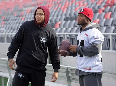 Injured Ottawa RedBlacks running backs Jonathan Williams, left and Michael Hayes (34) watch practice today at TD Place in Ottawa, Monday, October 27, 2014. The RedBlacks take on Hamilton Tiger-Cats this Friday at TD Place.