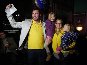 Innes ward winner Jody Mitic arrives with wife Alannah Gilmore and daughters Kierah, 2, and Aylah, 6, at Tartan Pub and Grill in Orleans for his victory party on election day in Ottawa on Oct. 27, 2014. Ward 2 incumbent Rainer Bloess, 63, didn't run for the seat, which he's held for 20 years.