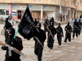 This image posted on a militant website on Tuesday, Jan. 14, 2014 shows fighters from the al-Qaida linked Islamic State of Iraq and the Levant (ISIL), now called the Islamic State group, marching in Raqqa, Syria. THE CANADIAN PRESS/AP, Militant Website