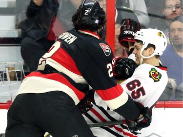 Jared Cowen of the Ottawa Senators hits Andrew Shaw of the Chicago Blackhawks during second period NHL action.