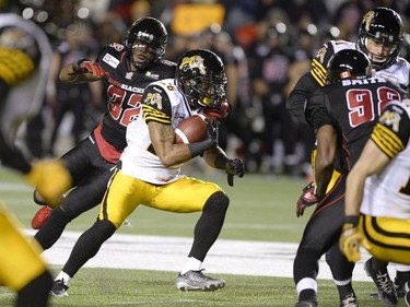 Hamilton Tiger-Cats Mossis Madu (26) s marked by Ottawa Redblacks Jermaine Robinson (32) during first half CFL action.