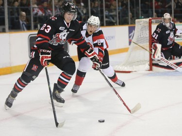Johnny Corneil, left, tries to keep Ben Fanjoy off the puck in the first period as the Ottawa 67's take on the Niagara Ice Dogs in their home opener at the renovated TD Place arena.