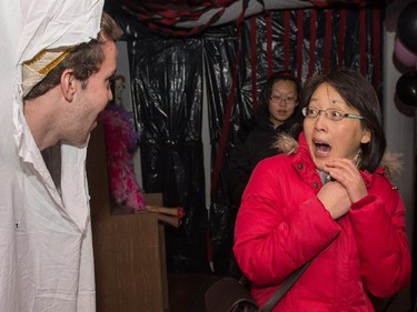 Julien Horwood scares Jenny Wong at Rideau Hall's Haunted Circus Friday evening.