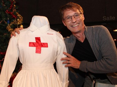 Local actor Guy Buller poses with such movie-themed decor as this nurse costume on display at the reception for the Ottawa premiere of the Elephant Song at the National Arts Centre on Monday, Sept. 29, 2014.