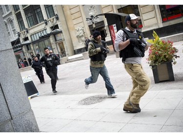 Heavily armed officers race down Sparks Street.