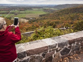 Many people including Margaret Baker, pictured, flocked to Champlain Lookout in Gatineau Park in Chelsea, QC Saturday October 11, 2014 to take in the fall colours.