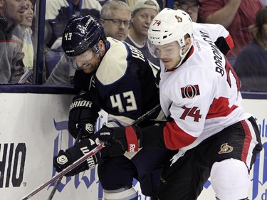 Ottawa Senators' Mark Borowiecki, right, and Columbus Blue Jackets' Scott Hartnell fight for a loose puck during the second period.