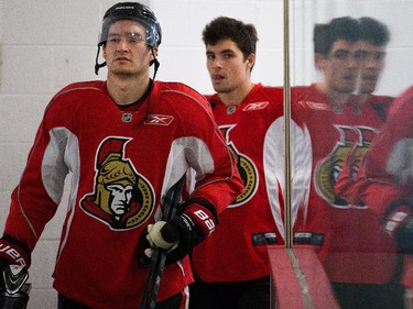 Mark Stone and Cody Ceci are reflected in the rink glass as the Ottawa Senators practice Wednesday afternoon at the Bell Sensplex.