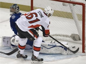 The Ottawa Senators' Mark Stone slips the puck past Tampa Bay Lightning goalie Ben Bishop on Saturday, Oct. 11, 2014, with his father there in Tampa, Fla., to see it.