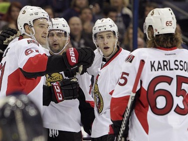 Ottawa Senators' Mark Stone, from left, Clarke MacArthur, Kyle Turris and Erik Karlsson, of Sweden, celebrate their goal against the Columbus Blue Jackets during the third period.