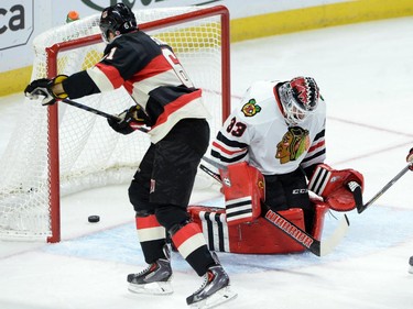 Ottawa Senators' Mark Stone puts the puck past Chicago Blackhawks' Scott Darling during first period NHL hockey action.