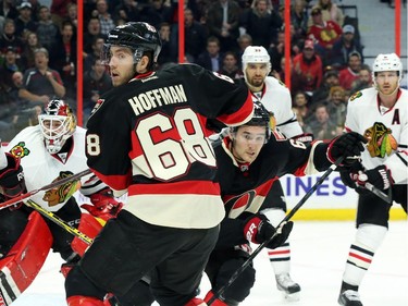 Mike Hoffman (68) and Mark Stone of the Ottawa Senators battle against the Chicago Blackhawks during first period NHL action.