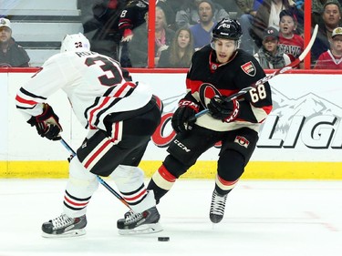 Mike Hoffman, right, of the Ottawa Senators seeks Michal Rozsival of the Chicago Blackhawks during first period NHL action.