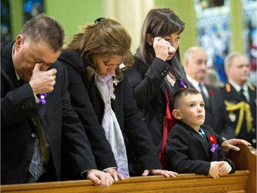 Kathy Cirillo, second left, cries with Natasha Cirillo, centre, and Marcus Cirillo, right, during the regimental funeral service.