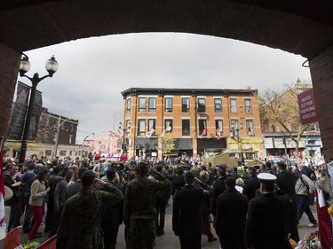 The coffin of Cpl. Nathan Cirillo is escorted past the armoury where he served toward his funeral service.