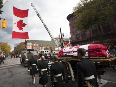 The body of Cpl. Nathan Cirillo is escorted through the streets toward his funeral service.