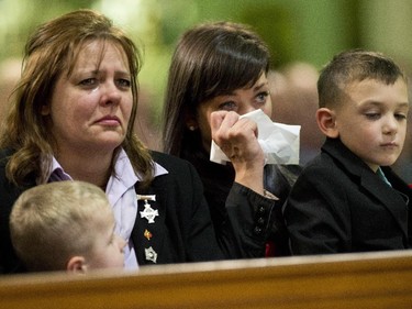 Kathy Cirillo, left, cries with Natasha Cirillo, centre, and Marcus Cirillo, right, during the regimental funeral service for her son, Cpl. Nathan Cirillo.
